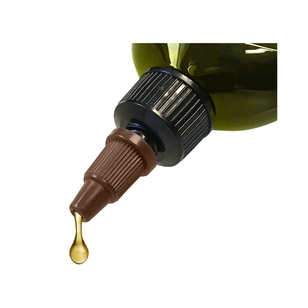 Close-up of a dropper bottle with a gold liquid drop on a white background