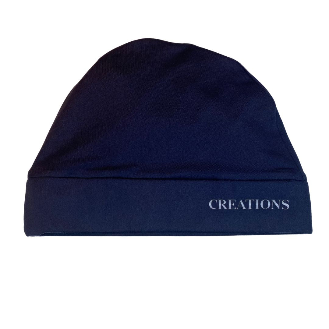 A dark blue satin lined beanie with the brand name 'Creations' visible on the front.