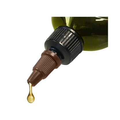Close-up of a dropper bottle with a gold liquid drop on a white background