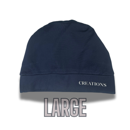 Navy blue beanie with 'CREATIONS' branding on a white background