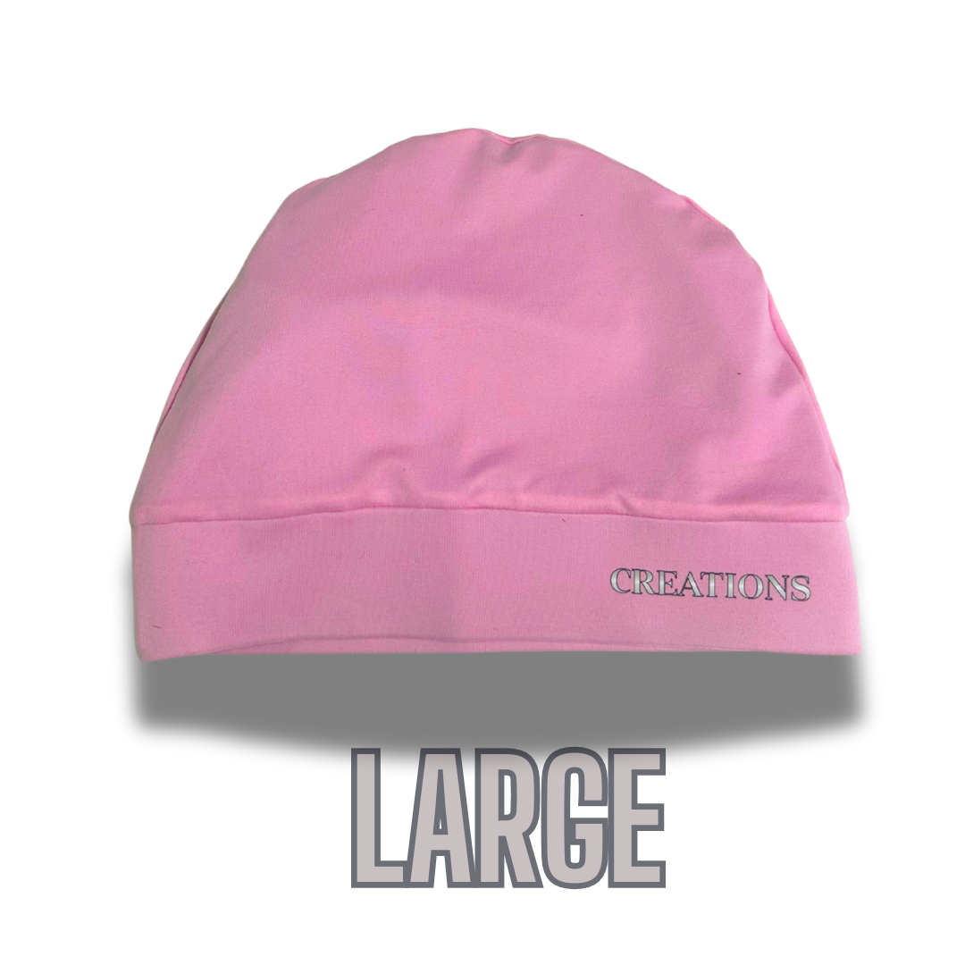 Pink beanie with 'CREATIONS' branding on a white background