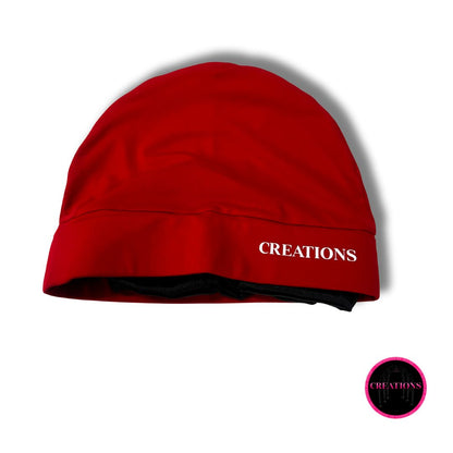 Red beanie with 'CREATIONS' branding on a white background