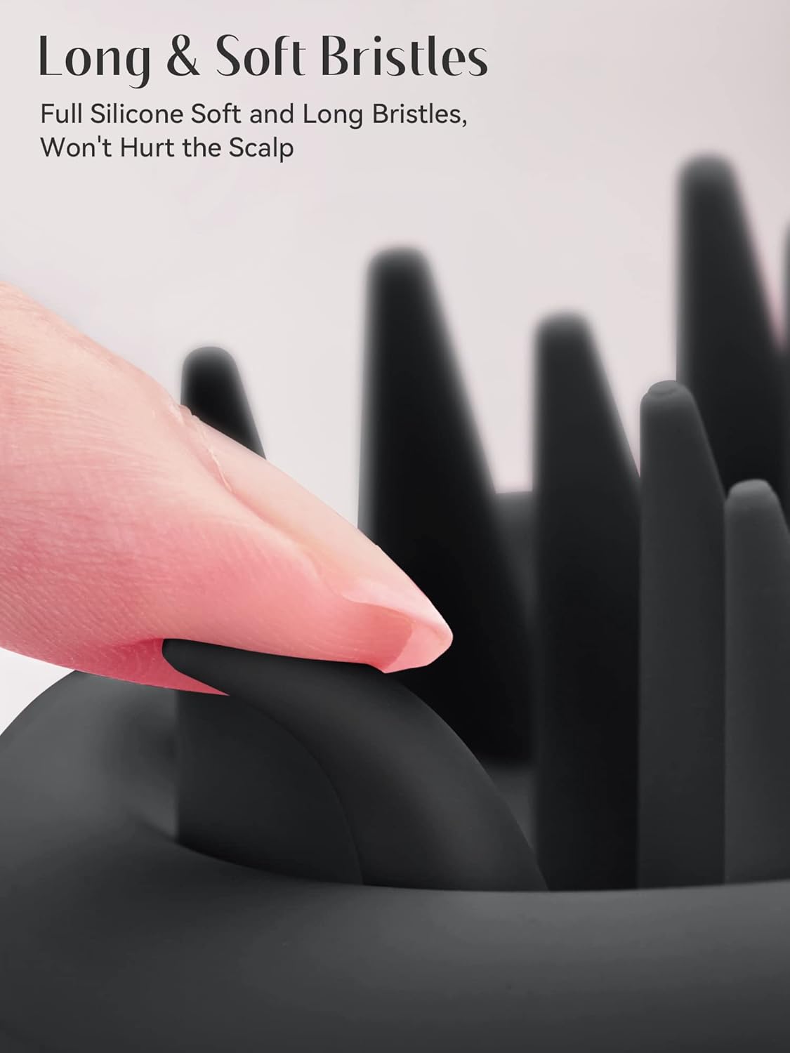 Black hairbrush with long, soft bristles being held by a hand.
